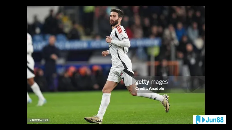 Besiktas player dribbling past Basaksehir defenders during a match Besiktas player dribbling past Basaksehir defenders during a match